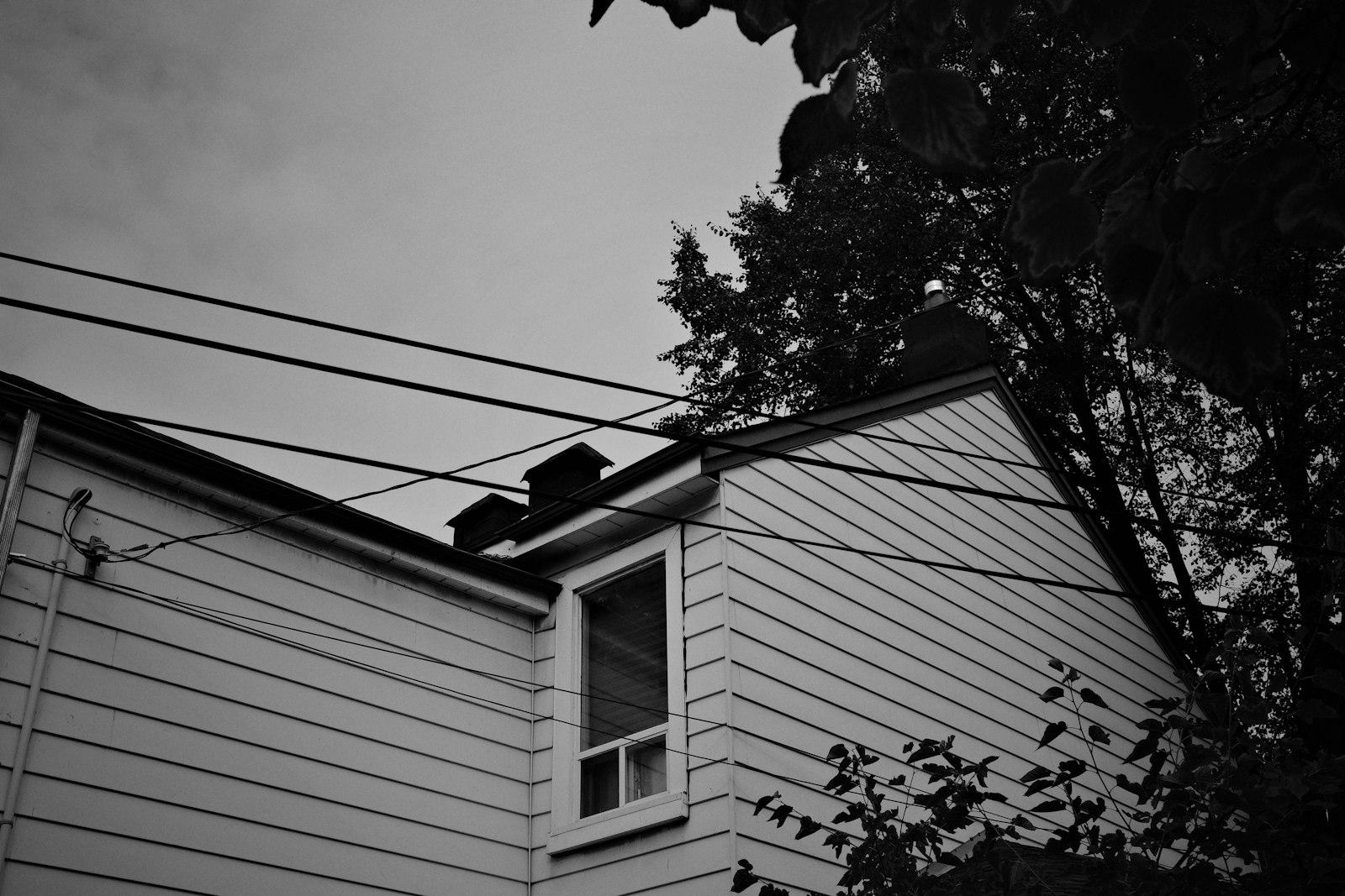 Overhead view of house with power lines and trees
